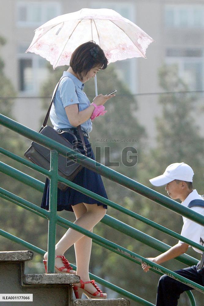 Woman using mobile phone in Pyongyang