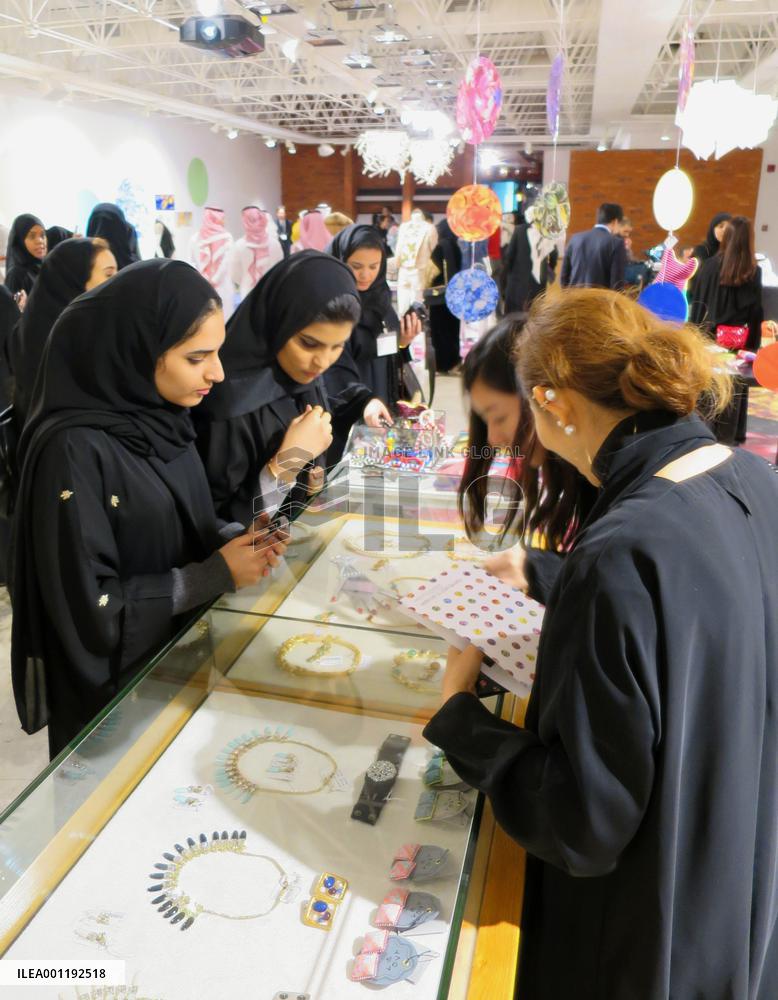 Saudi women look at accessories at Japan fair in Riyadh