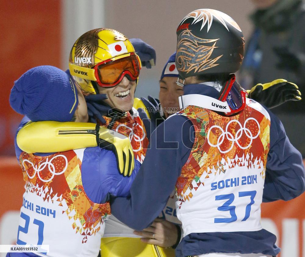 Large hill silver medalist Kasai hugs teammates