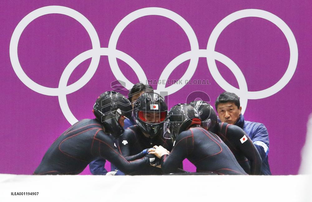 Team Japan huddles before starting men's bobsleigh race