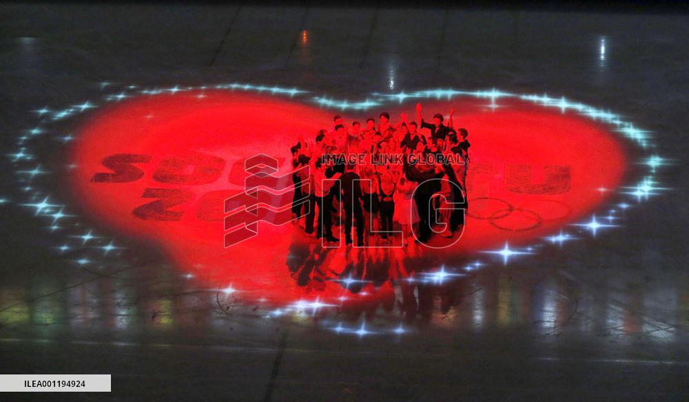 Figure skaters gather in heart-shaped illumination