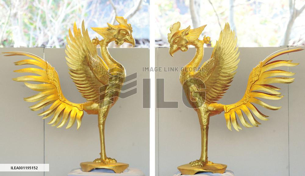 Newly gold-plated phoenix statues shown at Kyoto temple