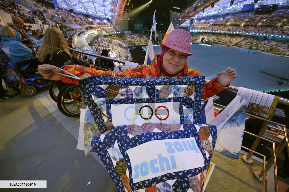 Woman shows patchwork before Paralympic opening ceremony