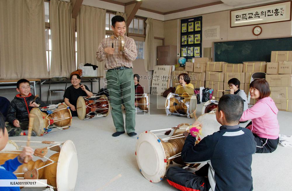 Japanese citizens practice traditional Korean drums