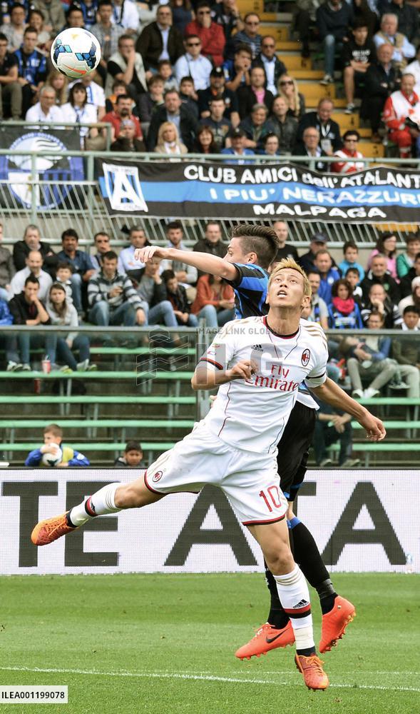 Milan's Honda vies for ball against Atalanta player