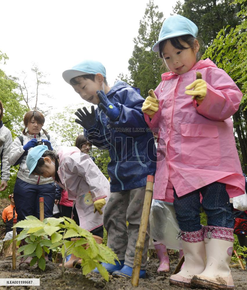 Children plant trees in 2011 quake-hit area