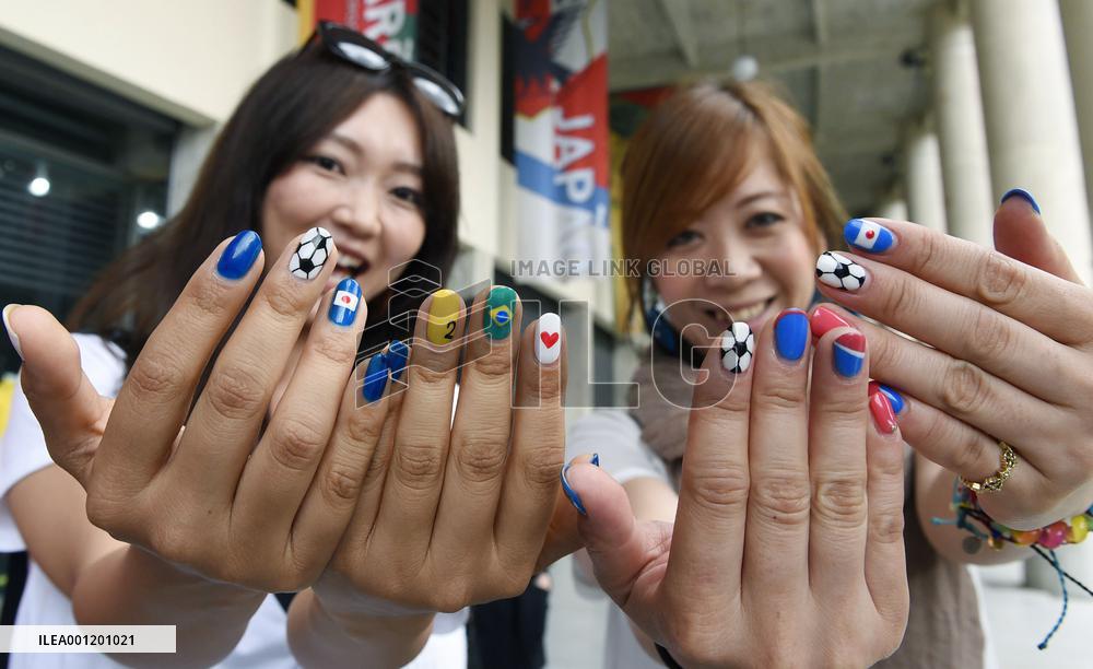 Japanese women show nails designed for World Cup