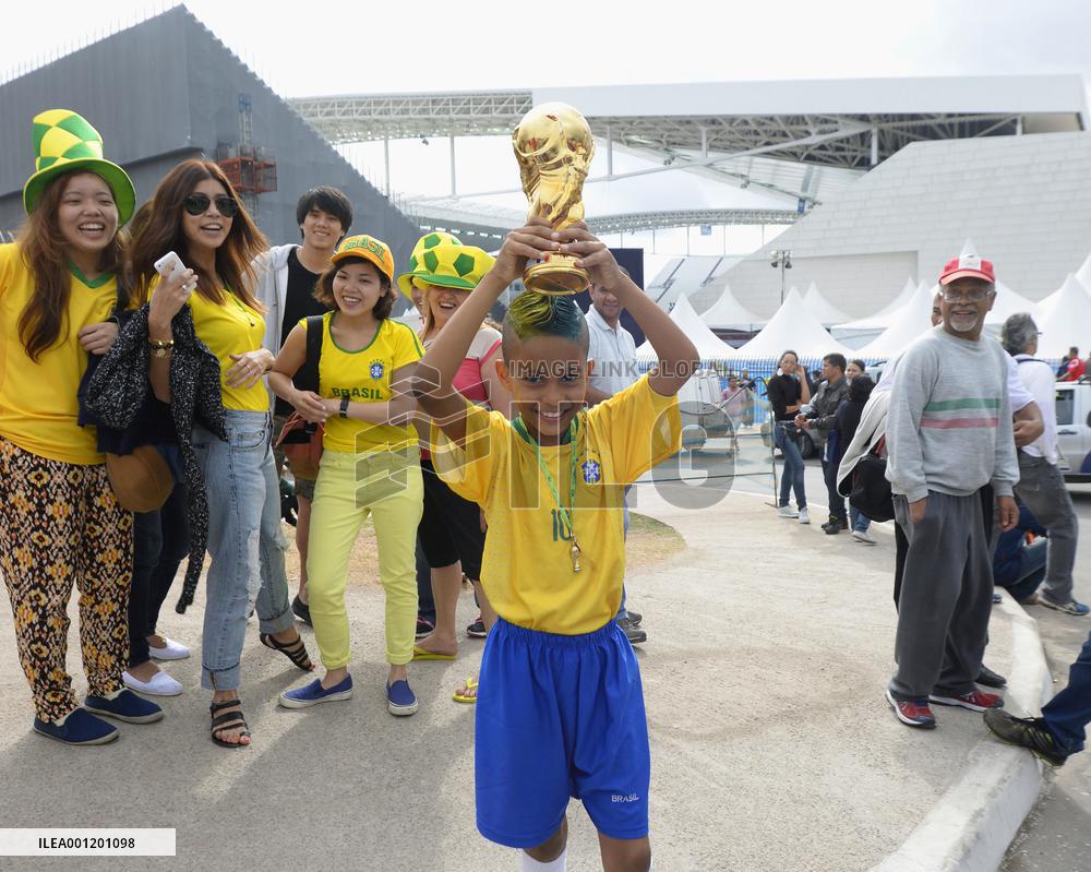 Boy holds 'World Cup' at Arena Corinthians