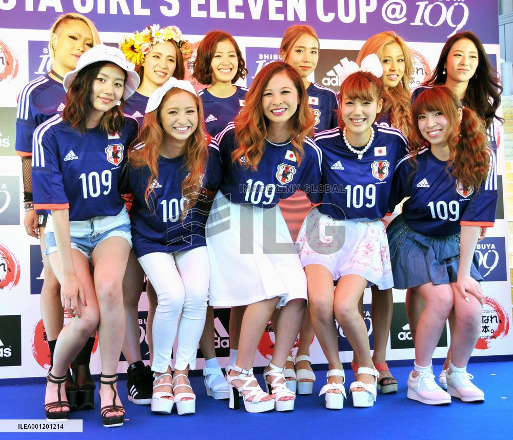 Sales clerks model at soccer shirt fashion contest