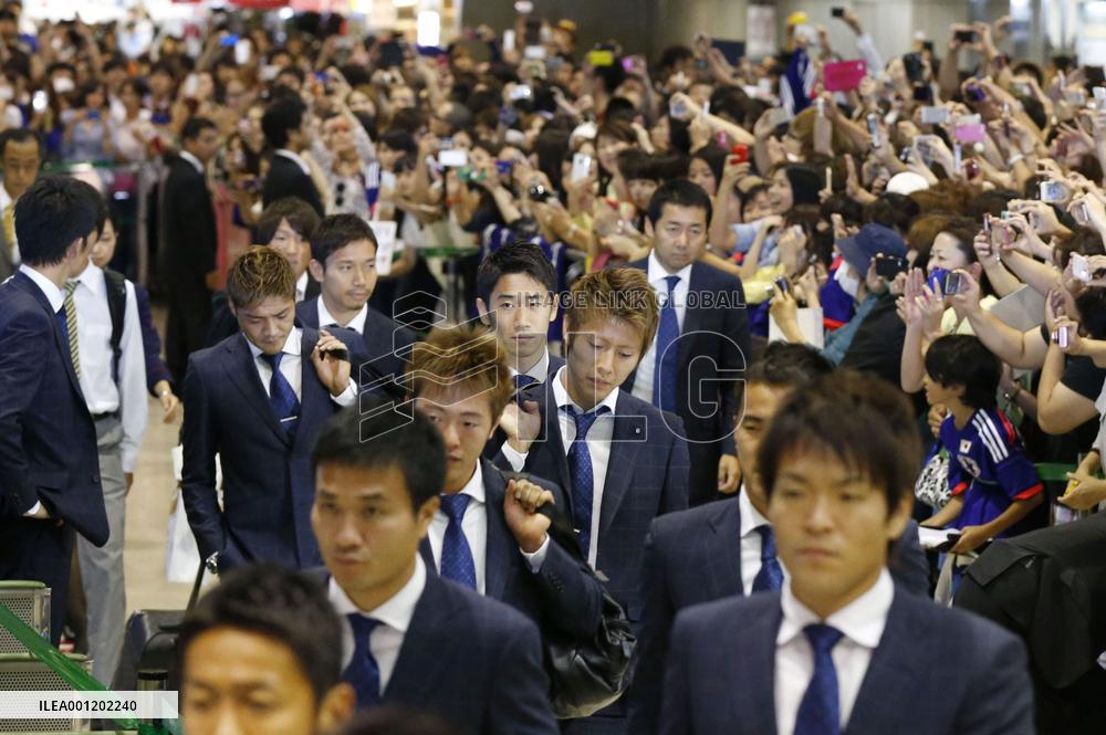 Japan team returns home from Brazil