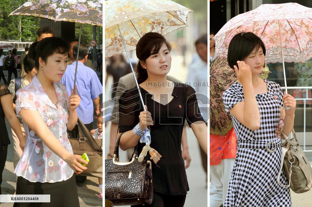 Women with colorful parasols in Pyongyang