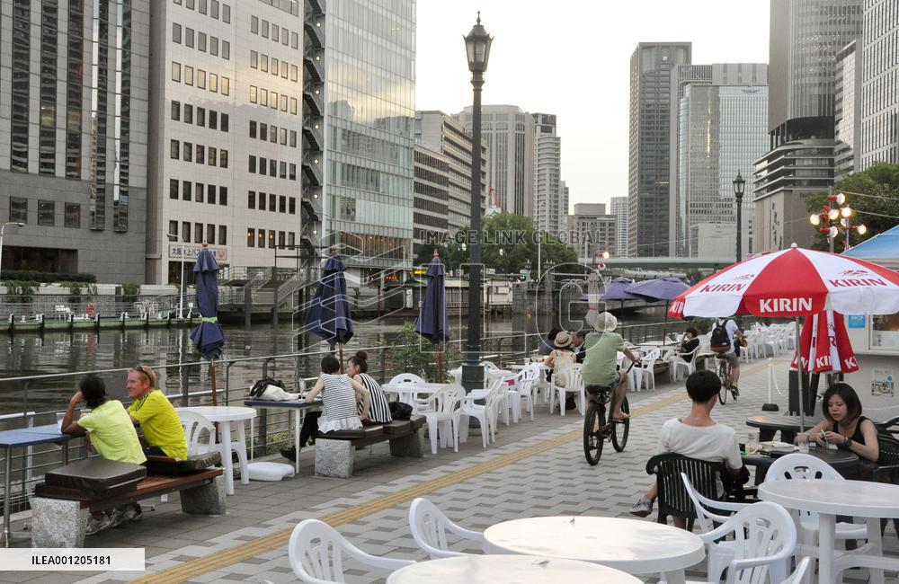 People relax at terrace created along Osaka river