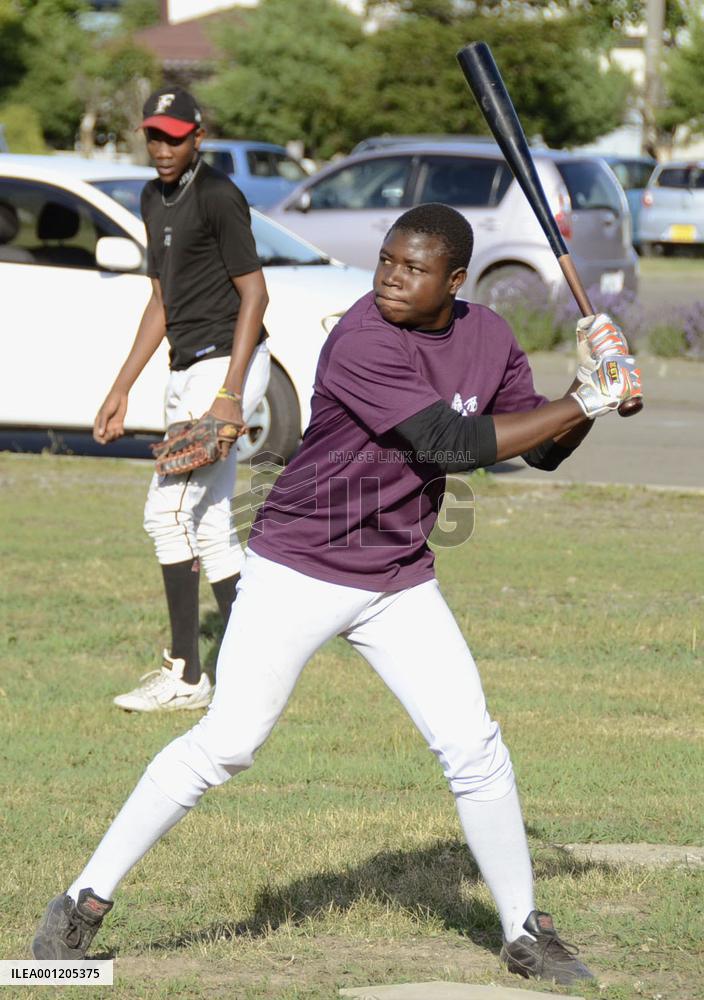 Young African practices baseball batting in Japan
