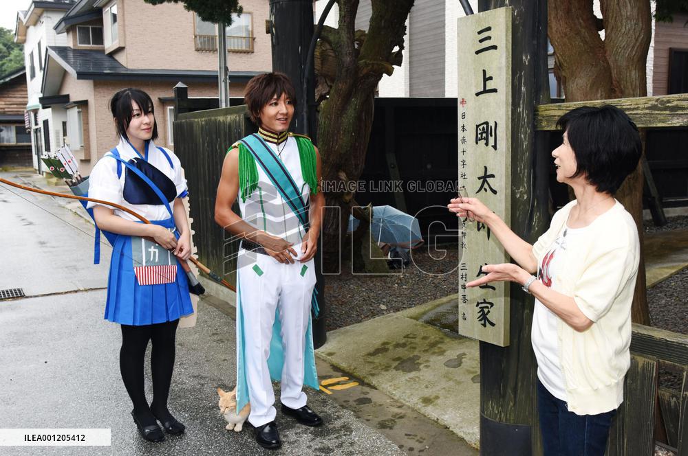 Costume play lovers listen to guide at old residence