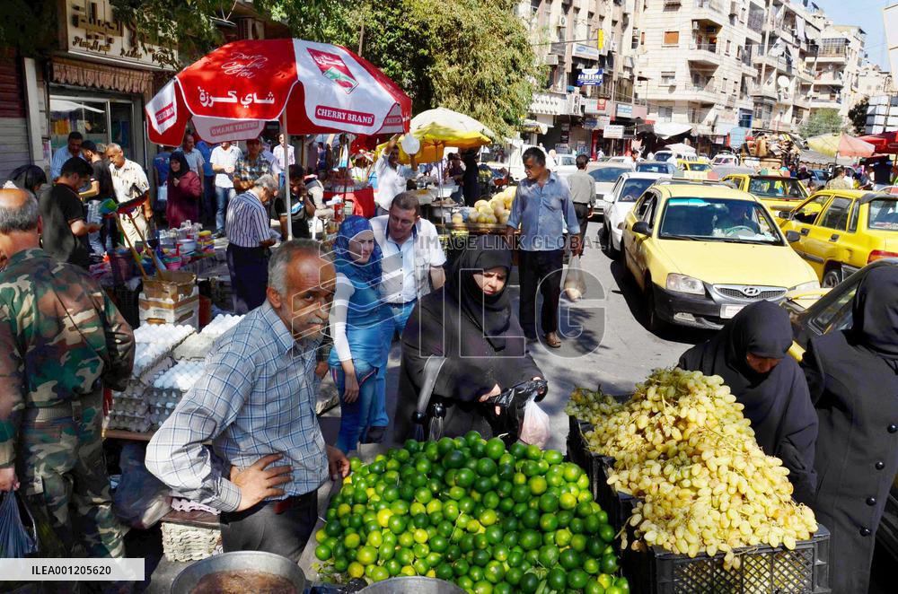Street with shoppers in Aleppo, Syria