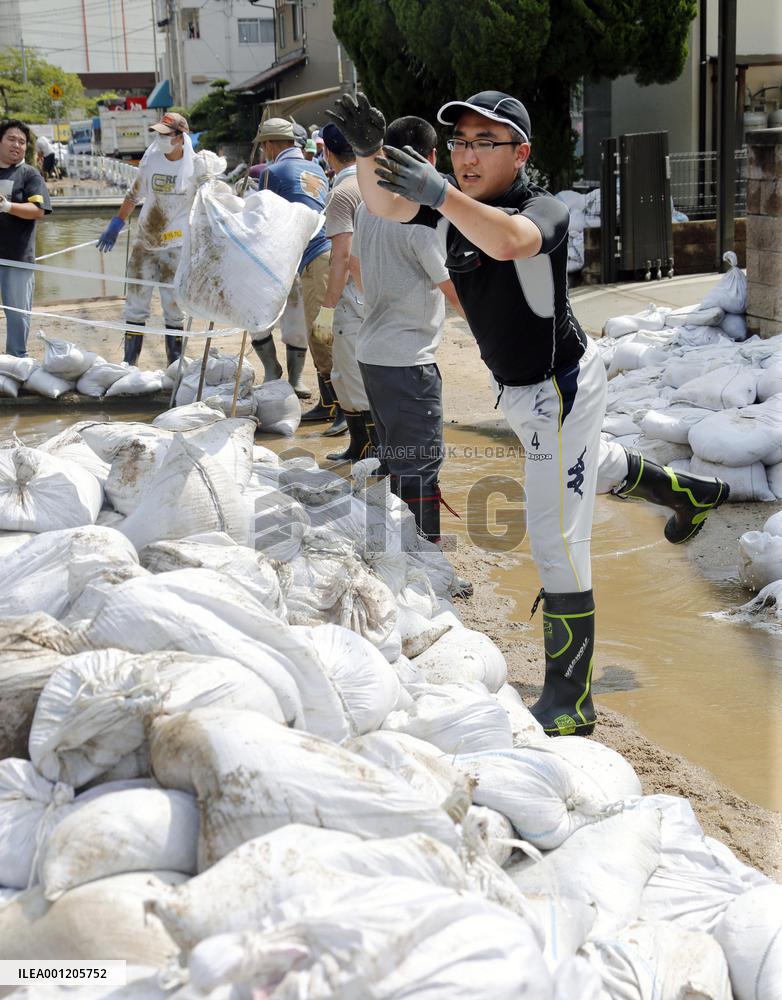 Volunteers carry out mud in mudslide-hit area in Hiroshima