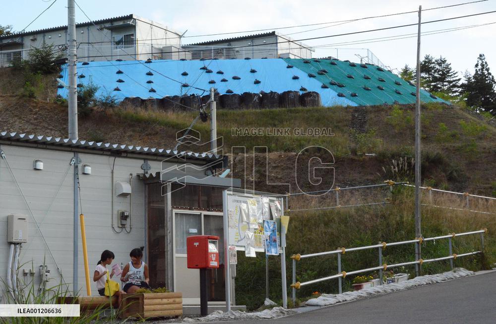 Temporary homes for quake victims stand on reinforced hill