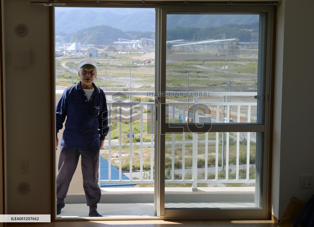 Man checks apartment built for 2011 disaster evacuees