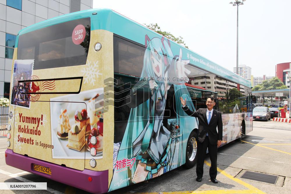 Sapporo deputy mayor shows bus to promote Hokkaido