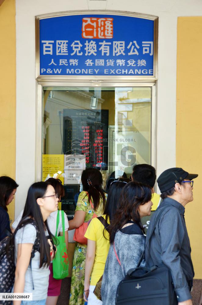 Tourists from China visit money changer in Macao