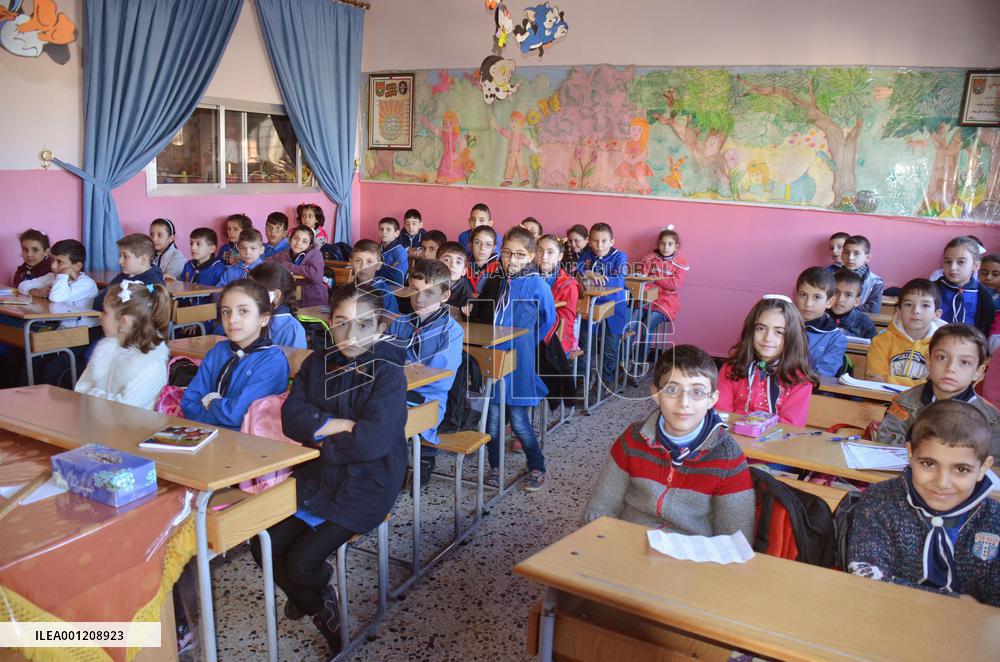 Pupils study at Syrian school after explosion