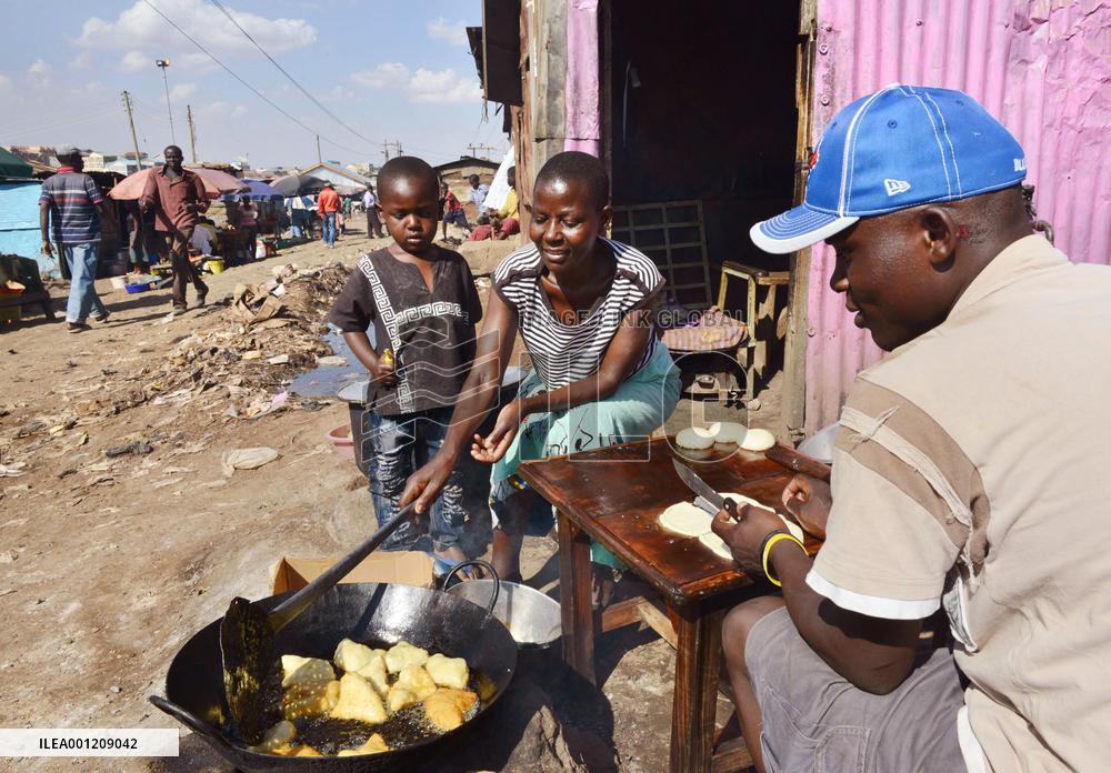 Kenyan woman cooks fried bread in slum