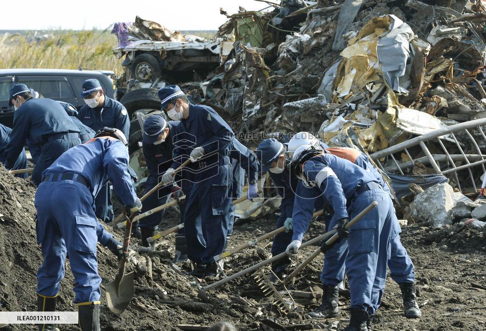 Fukushima police comb debris in coastal areas