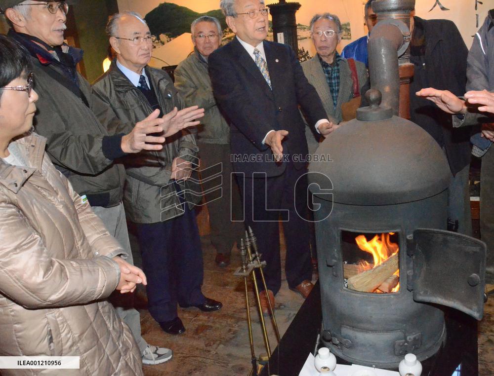 People surround replica of Japan's 1st stove