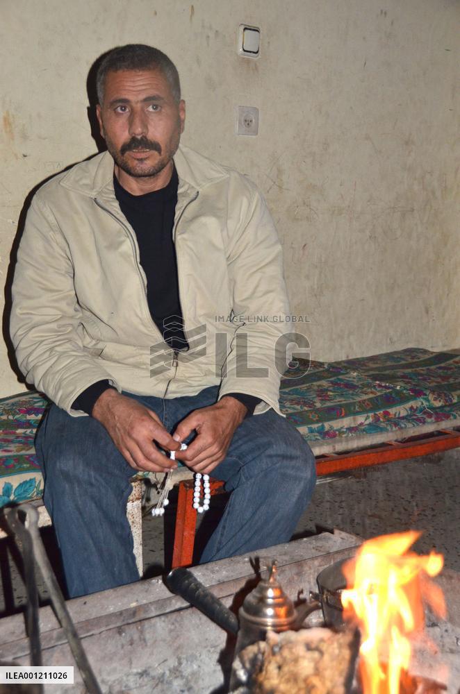Palestinian man sits in damaged Gaza home