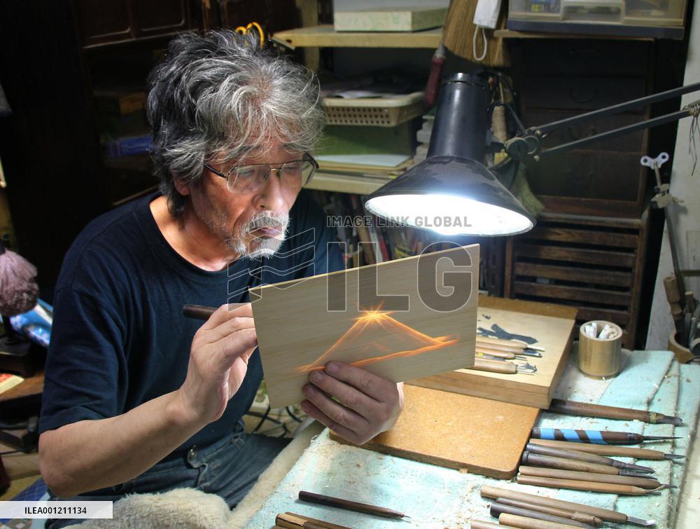 Sculptor works on bamboo openwork