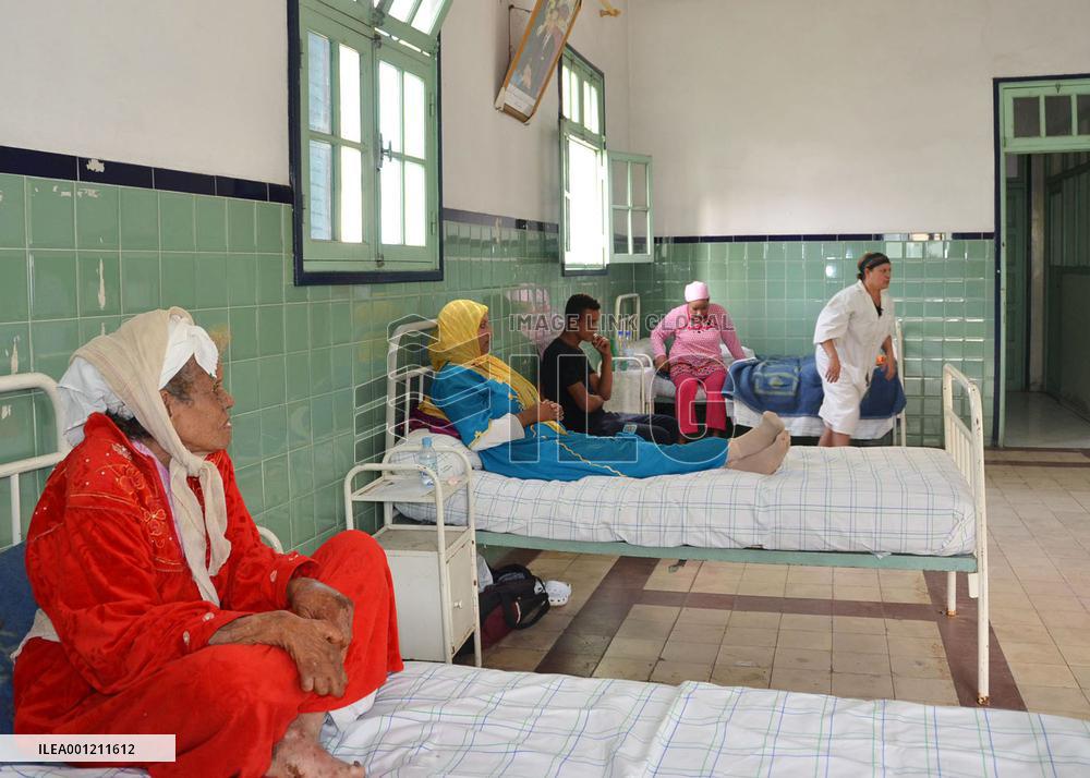 Leprosy patients sit on beds in Casablanca suburb