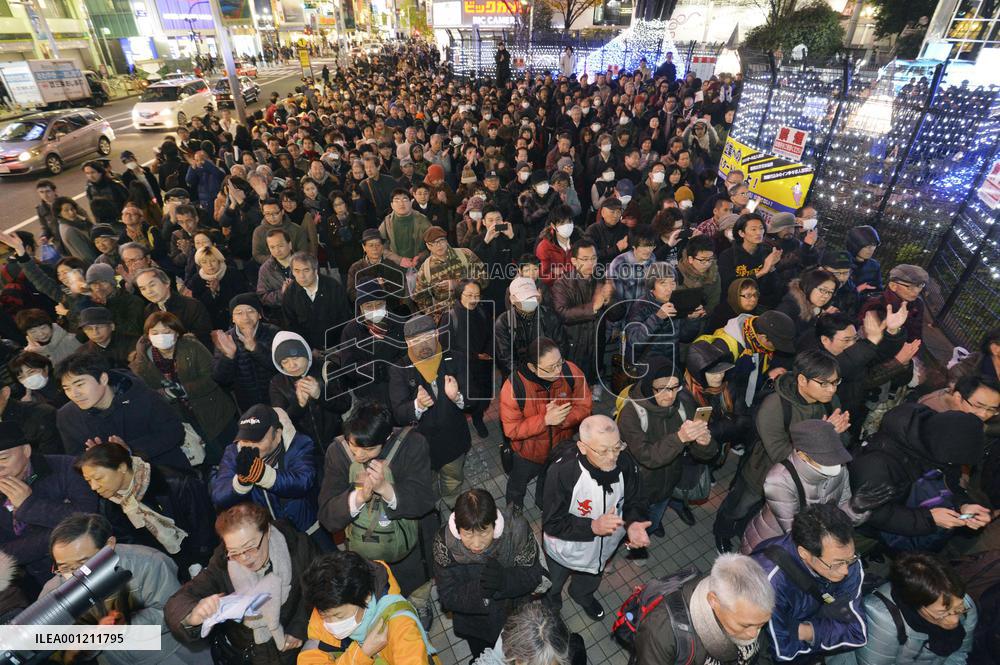 People listen to a street speech on final day of campaign