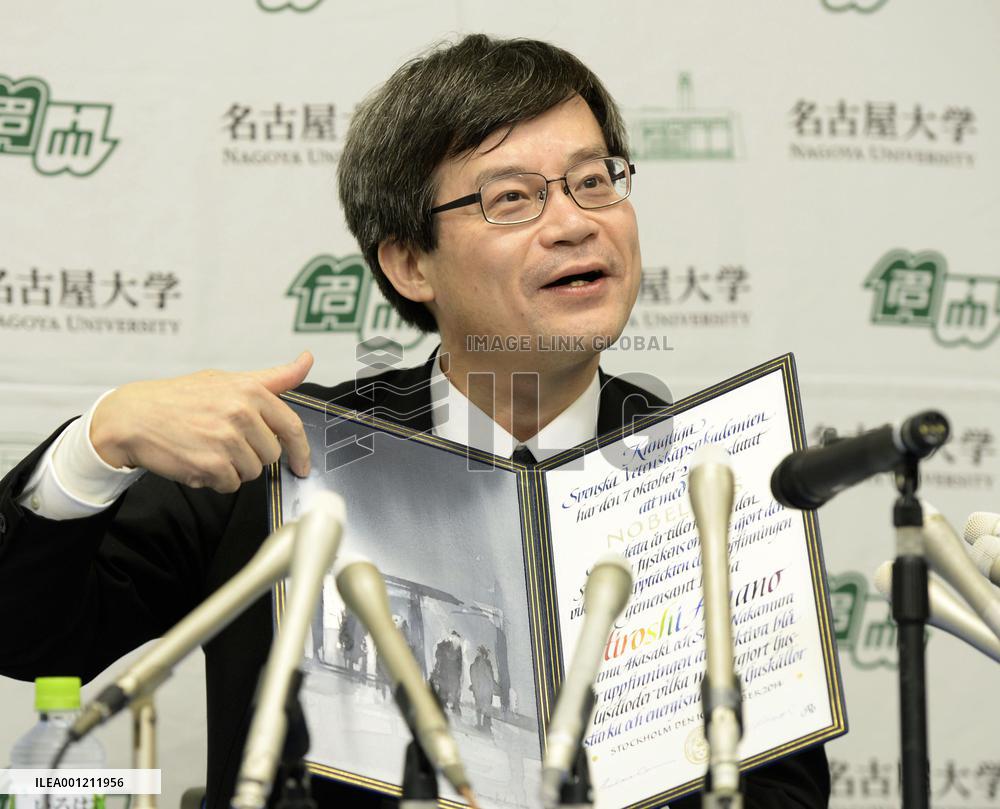 Nobel laureate Amano shows certificate upon return home