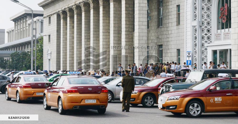 Taxis await passengers in front of Pyongyang Station