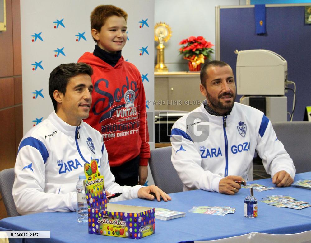 Players of scandal-hit Zaragoza pose with supporter