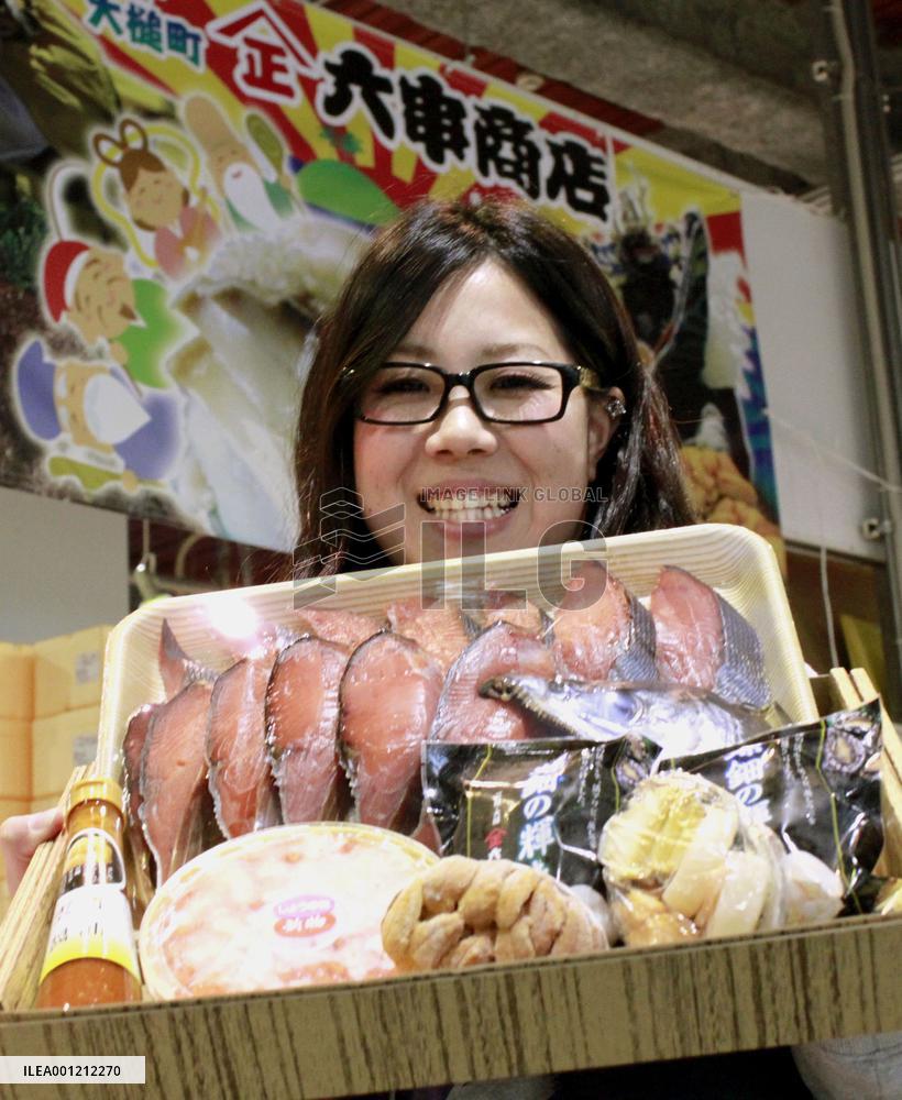 Worker in tsunami-hit town shows off marine products