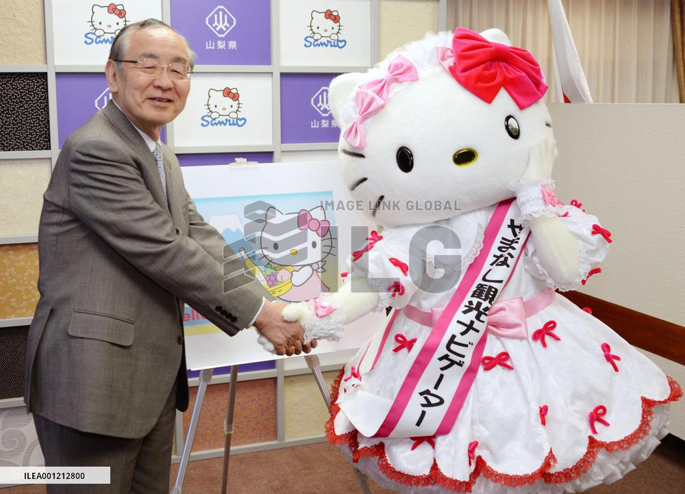 Yamanashi Gov. Yokouchi shakes hands with Hello Kitty