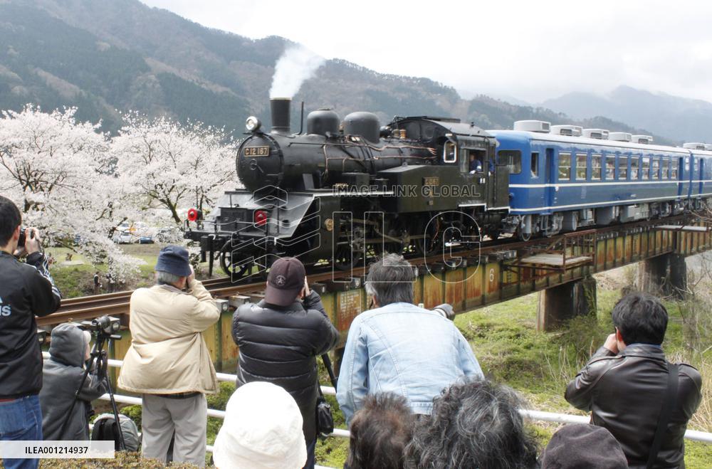 Steam locomotive train runs on bridge in Tottori Pref.