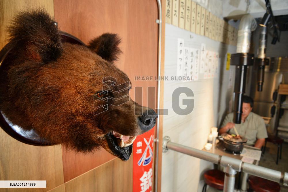 Stuffed bear head hangs on wall at Tokyo game meat restaurant