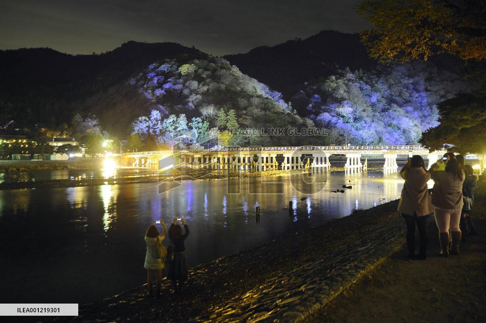 Kyoto's bridge, foothills lit up ahead of lantern festa