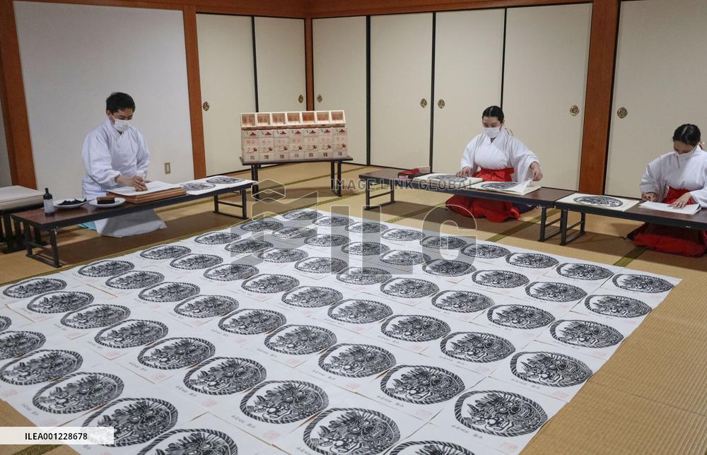 Making of paper charms at Japanese shrine