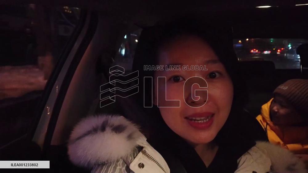 Tourists take ice-and-snow tourism train to skiing resorts in Xinjiang