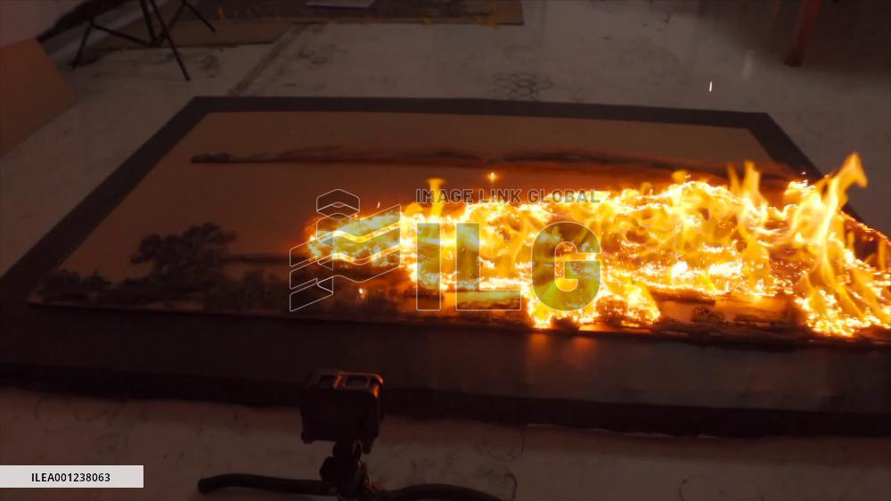 Chinese artist creates painting with fire