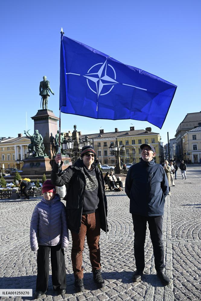 People celebrating the Nato membership of Finland