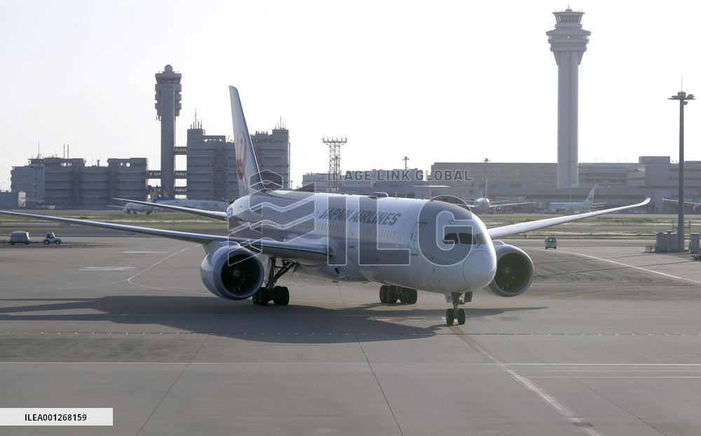 CORRECTED: Plane with evacuees arrives in Tokyo