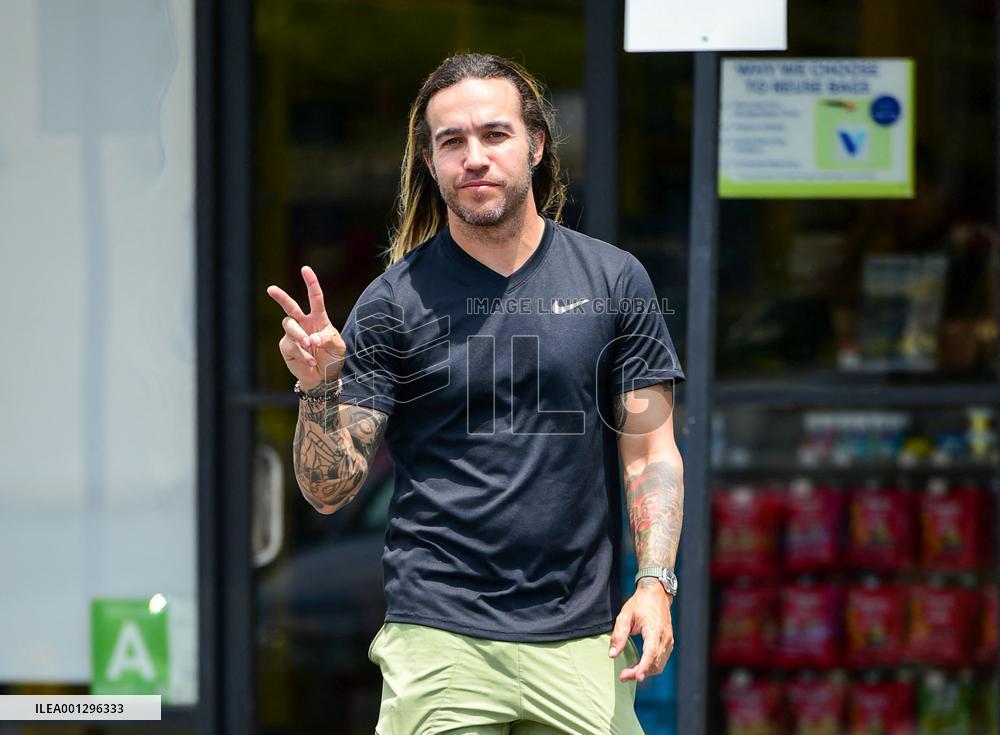 Pete Wentz Flashes The Peace Sign - LA