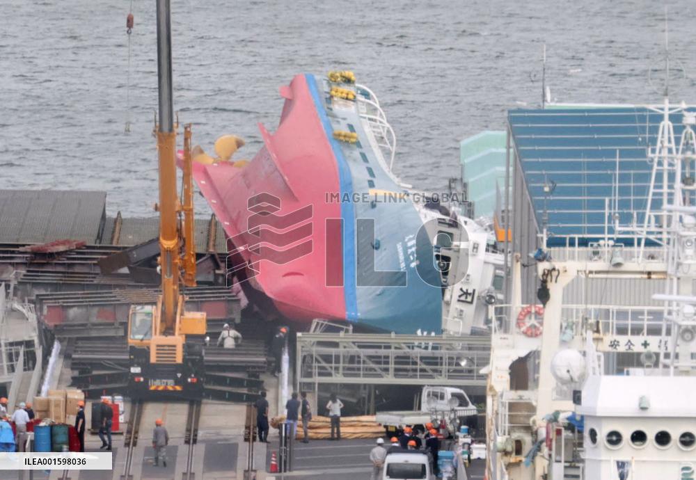 Overturned fishing vessel at northeastern Japan shipyard