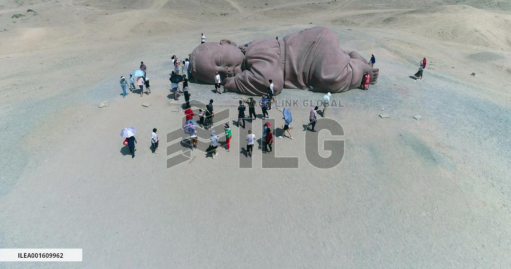 The Sculpture Son of the Earth on The Gobi Beach in Guazhou