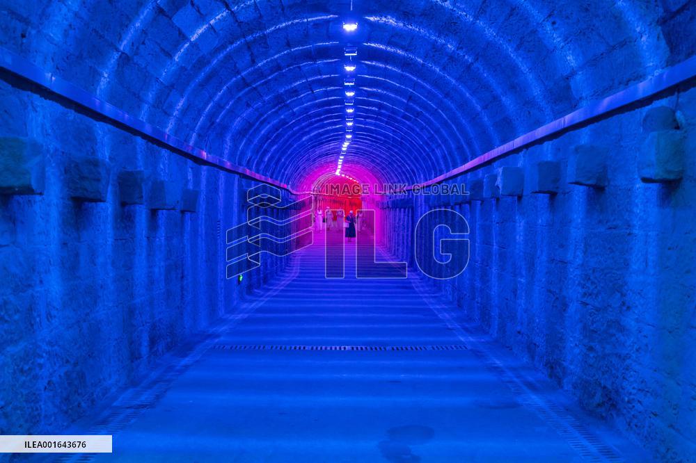Citizens and tourists play in a converted bomb shelter in Chongqing, China, August 26, 2023. The shelter is illuminated by light