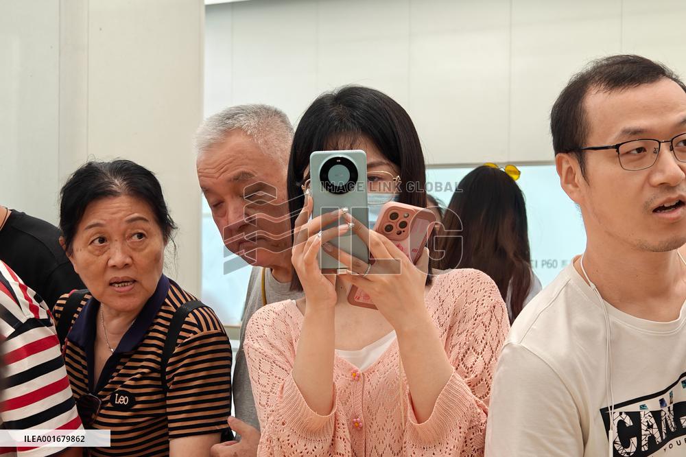 Customers Try Huawei's Mate60 Pro Mobile Phone in Shanghai